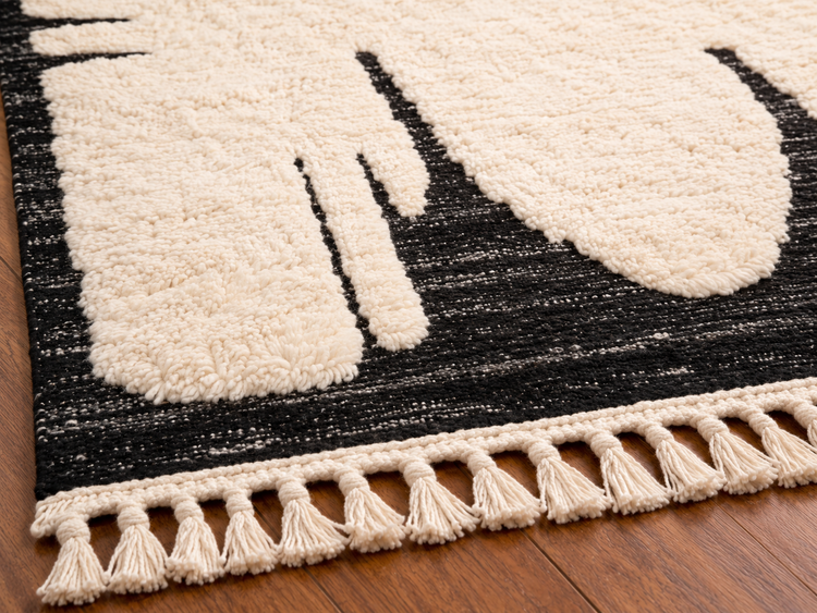 Handmade Moroccan black and white abstract wool rug fringe and texture close-up
