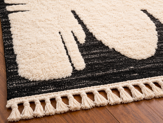 Handmade Moroccan black and white abstract wool rug fringe and texture close-up