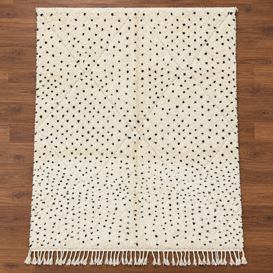 Full view of handmade Moroccan ivory and black dotted wool rug on warm walnut wood floor